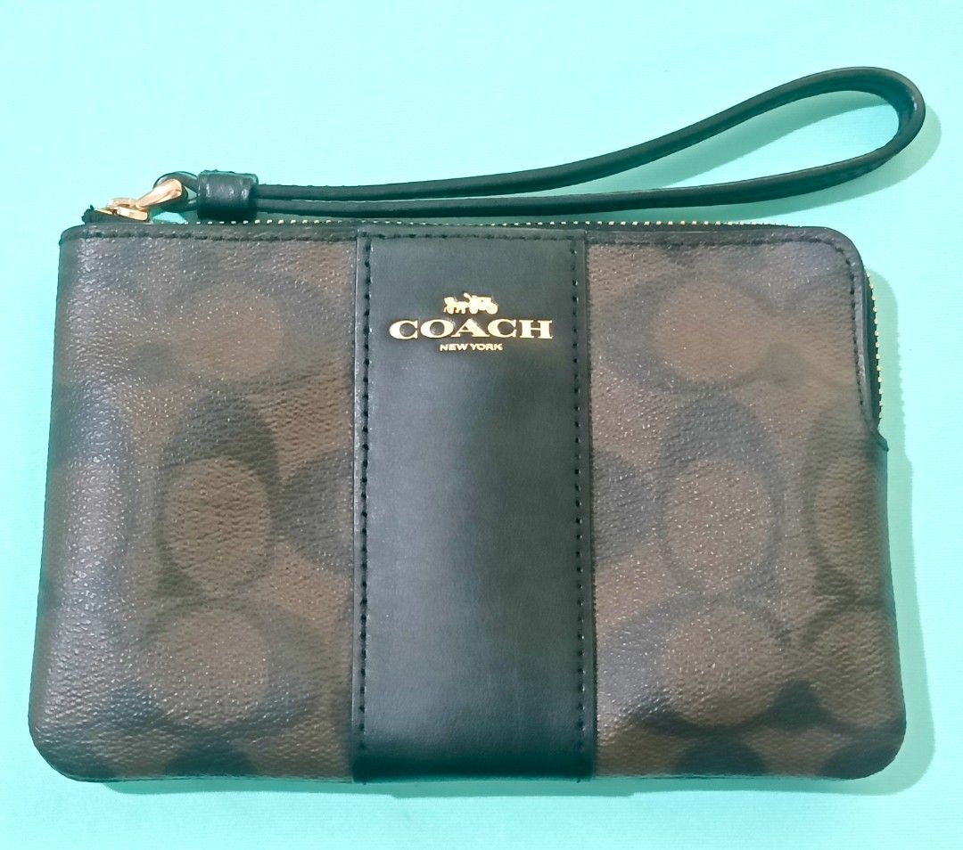 Coach Wristlet Brown Signature (Category: Luxury Bags & Wallets) located in Manila. Submitted by audrey03 (Listing ID 1397332922, Image 1). Description: - Coach wristlet - Brown signature pattern - Black leather accent - Zip closure - Wrist strap - Gold Coach logo - Stylish and practical pre -owned but never been used.
