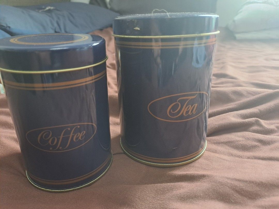 Coffee and Tea Canisters (Category: Coffee & Tea Tableware) located in Manila. Submitted by joanbalde39643 (Listing ID 1397254009, Image 2). Description: - Set of two canisters - For coffee and tea - Blue with gold accents - Cylindrical shape - Features lids - Elegant "Coffee" and "Tea" labels - Made of metal.