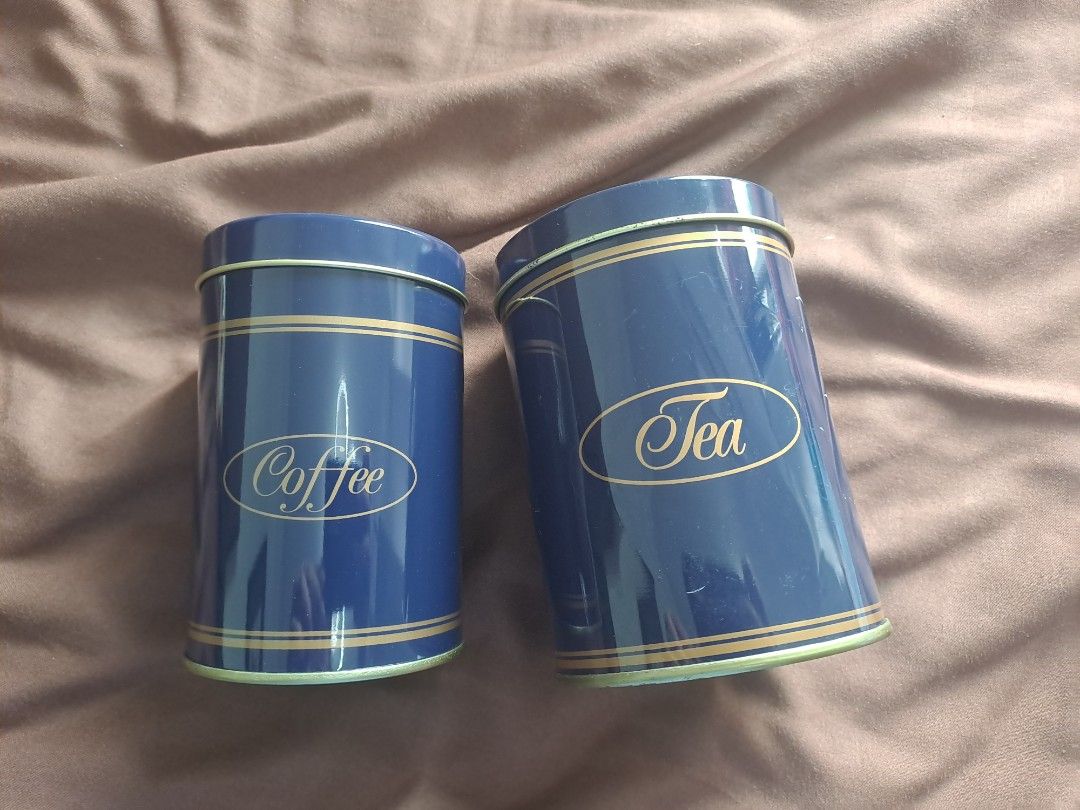 Coffee and Tea Canisters (Category: Coffee & Tea Tableware) located in Manila. Submitted by joanbalde39643 (Listing ID 1397254009, Image 1). Description: - Set of two canisters - For coffee and tea - Blue with gold accents - Cylindrical shape - Features lids - Elegant "Coffee" and "Tea" labels - Made of metal.