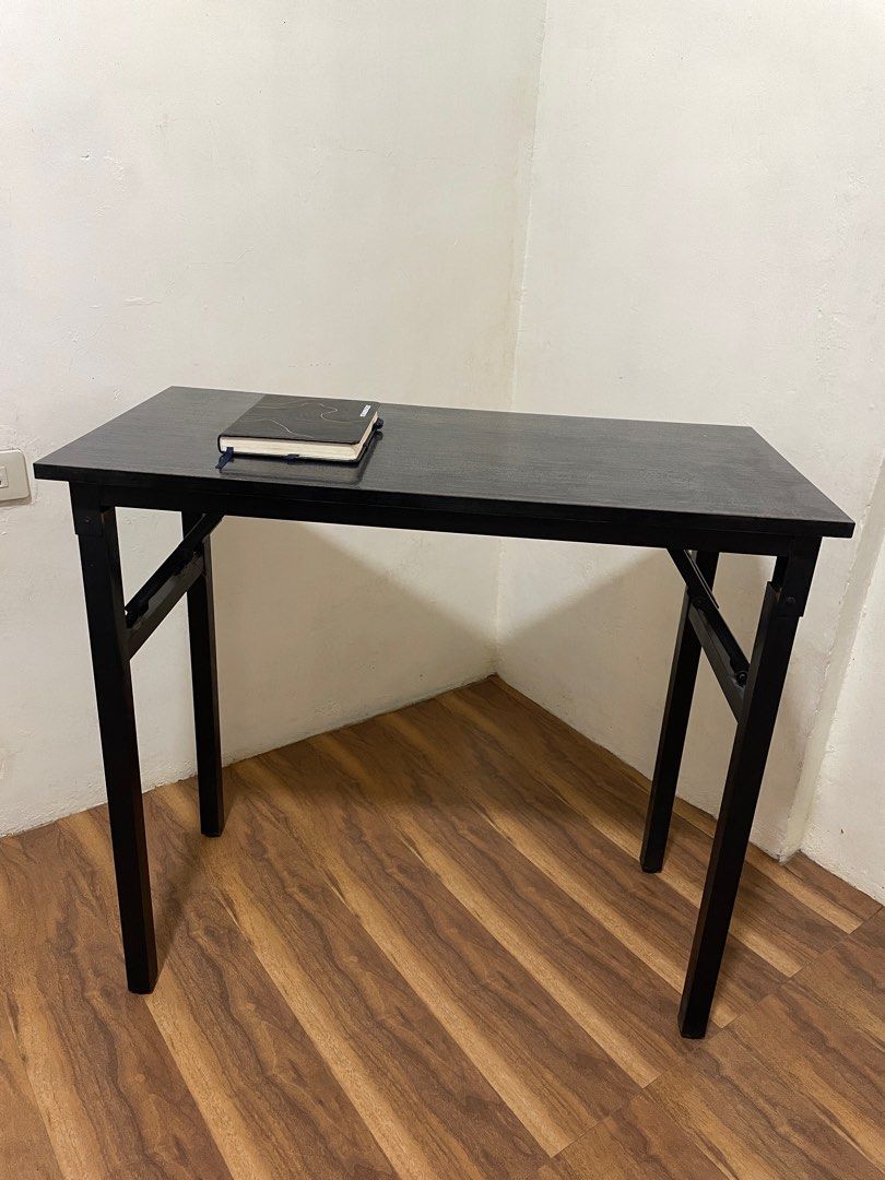 Foldable Study Table - Black (Category: Tables & Sets) located in Quezon City. Submitted by mikeconde (Listing ID 1397244431, Image 2). Description: - Foldable study table - Sleek black design - Rectangular tabletop - Sturdy legs - Compact size, ideal for small spaces - Perfect for studying or working from home - Easy storage due to foldable design.