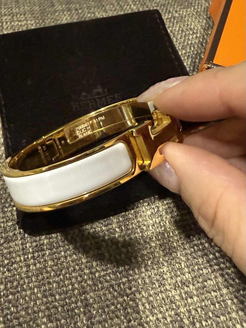 Hermes Le Bracelet (Category: Luxury Accessories) located in Mandaluyong City. Submitted by margabell (Listing ID 1397229203, Image 3). Description: - Authentic Hermes Clic H bracelet - Gold finish - White enamel band - Includes original box - Includes dust bag - Stickers intact - Bought in SG boutique.