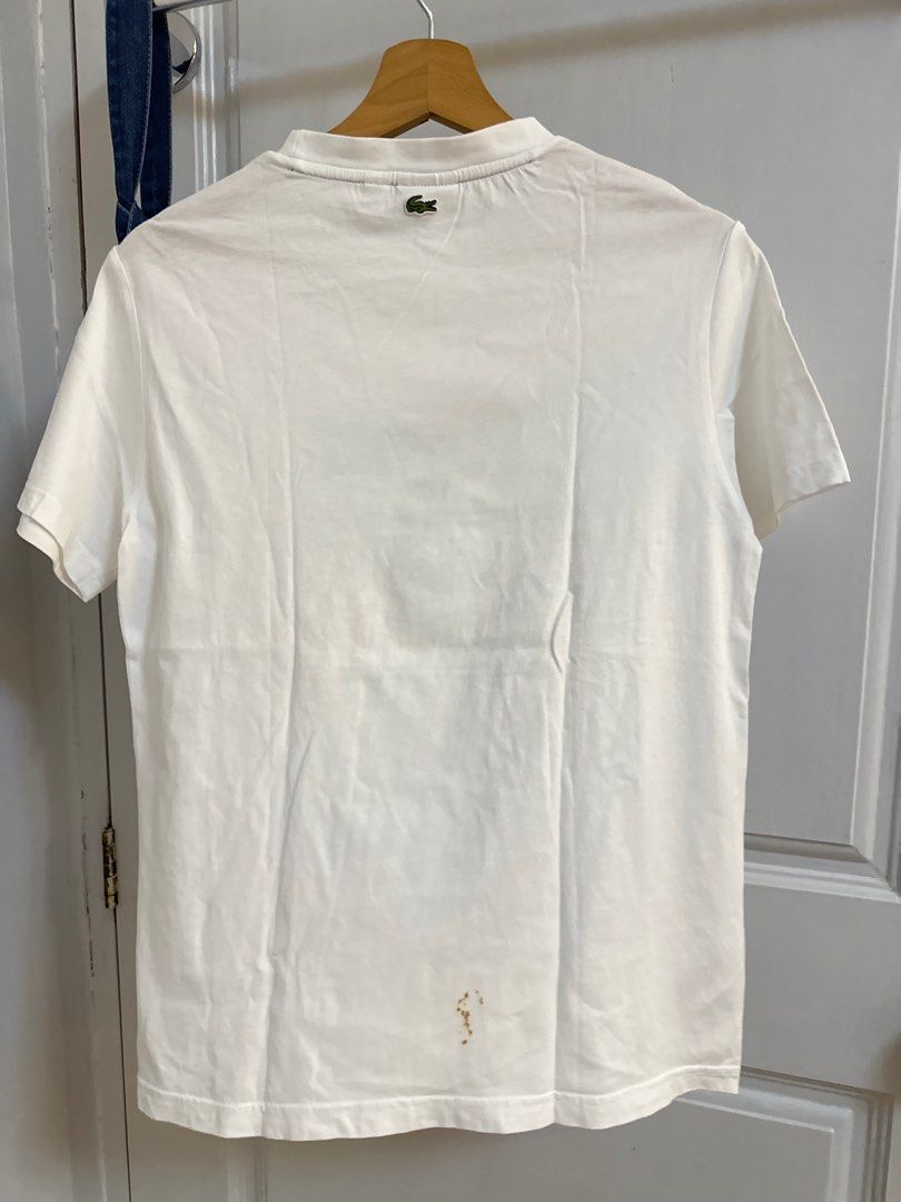 Lacoste White T-shirt Teens (Category: Tshirts & Polo Shirts ) located in Pasig City. Submitted by 4mscloset (Listing ID 1397359025, Image 3). Description: - Lacoste T-shirt - Size: 16 - Made in Tunisia - Features: Green logo and collar trim - Condition: Some stains on lower back.