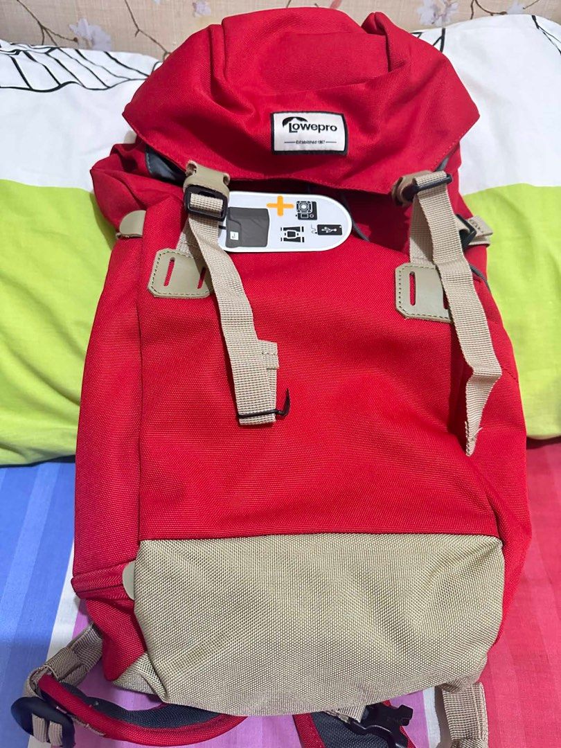 Lowepro Photo Backpack (Category: Backpacks) located in Quezon City. Submitted by marcelm.921 (Listing ID 1397282980, Image 1). Description: - Lowepro camera backpack - Color: Red and beige - Adjustable straps - Top flap closure - Padded back support for comfort - Includes tag with usage illustrations - Designed for camera equipment.