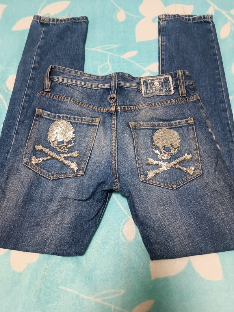 Mastermind Japan Skull Jeans (Category: Jeans) located in Quezon City. Submitted by geraldkimj97140 (Listing ID 1397359099, Image 3). Description: Stylish Mastermind Japan jeans with unique skull and crossbones detailing. Features a distressed design with patches and a size 29 waist. The jeans have a classic five-pocket design and a button closure. The back pockets are adorned with sequined skull and crossbones. The jeans also have a small skull 