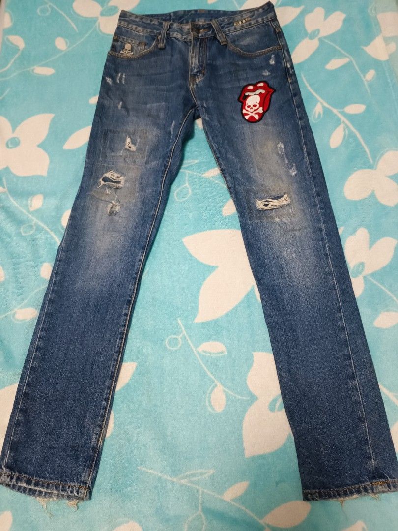 Mastermind Japan Skull Jeans (Category: Jeans) located in Quezon City. Submitted by geraldkimj97140 (Listing ID 1397359099, Image 1). Description: Stylish Mastermind Japan jeans with unique skull and crossbones detailing. Features a distressed design with patches and a size 29 waist. The jeans have a classic five-pocket design and a button closure. The back pockets are adorned with sequined skull and crossbones. The jeans also have a small skull 