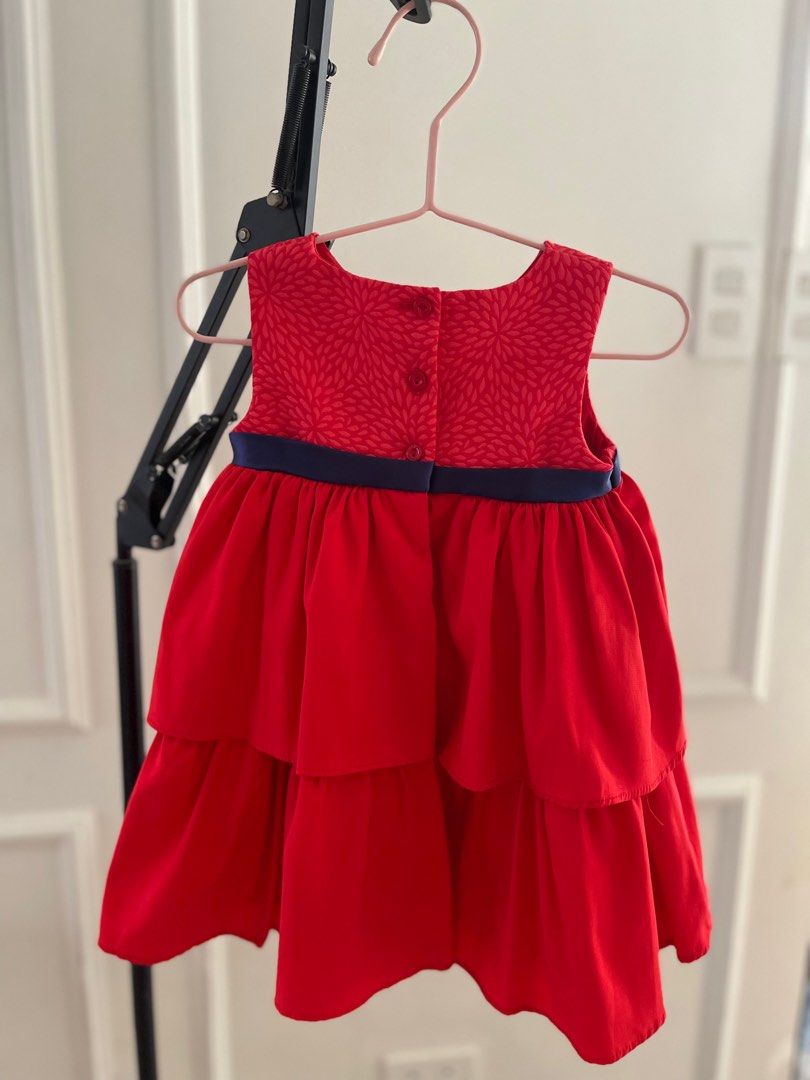 Periwinkle Red Tiered Dress with Bow (Category: Babies & Kids Fashion) located in Paranaque City. Submitted by jamrct (Listing ID 1397375571, Image 3). Description: - Adorable red dress - Tiered skirt - Navy blue bow detail - Floral patterned bodice - Navy ribbon at waist - Round neckline - Buttons at the back - Perfect for special occasions and everyday wear.