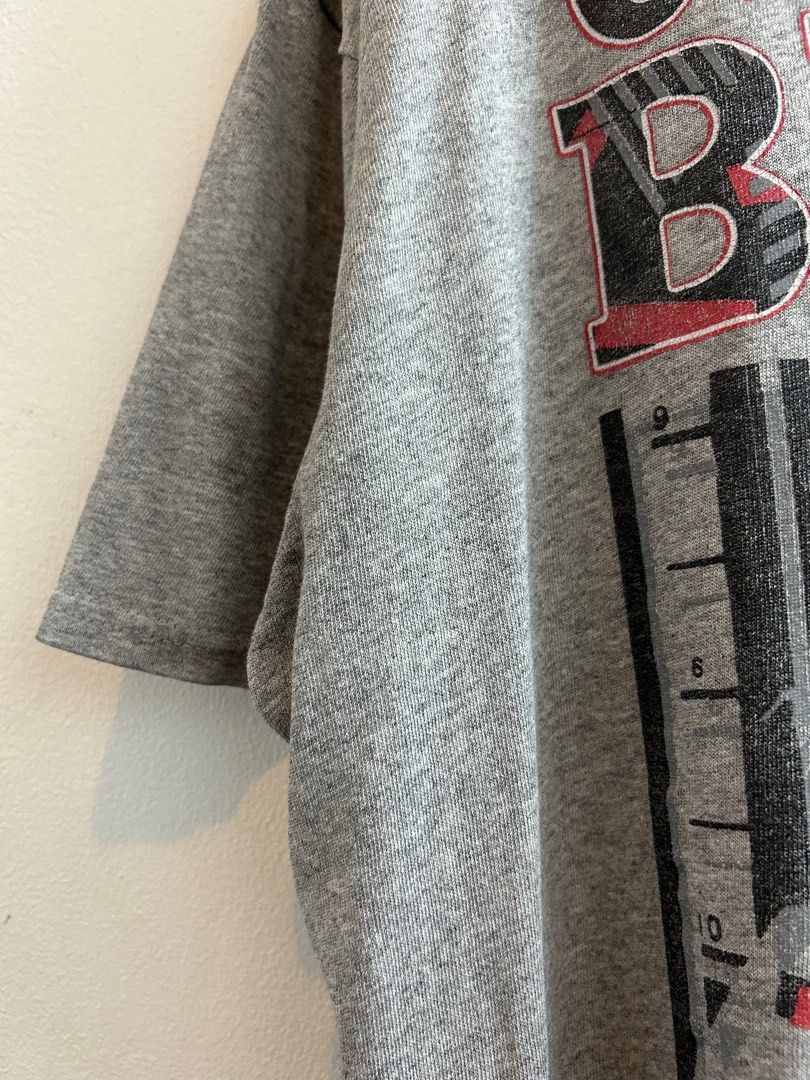 Chicago Bulls Graphic Tee (Category: Tshirts & Polo Shirts ) located in Paranaque City. Submitted by stfunasherramirez (Listing ID 1401591968, Image 3). Description: Size: XXL on tag Dimes: L31 W24.5 Condition: 9.5/10 Color rate: 10/10 - excellent fabric - excellent condition - Chicago Bulls graphic tee - Gray color - Features a classic Bulls design - Perfect for fans Issue: - pin holes. (See image).