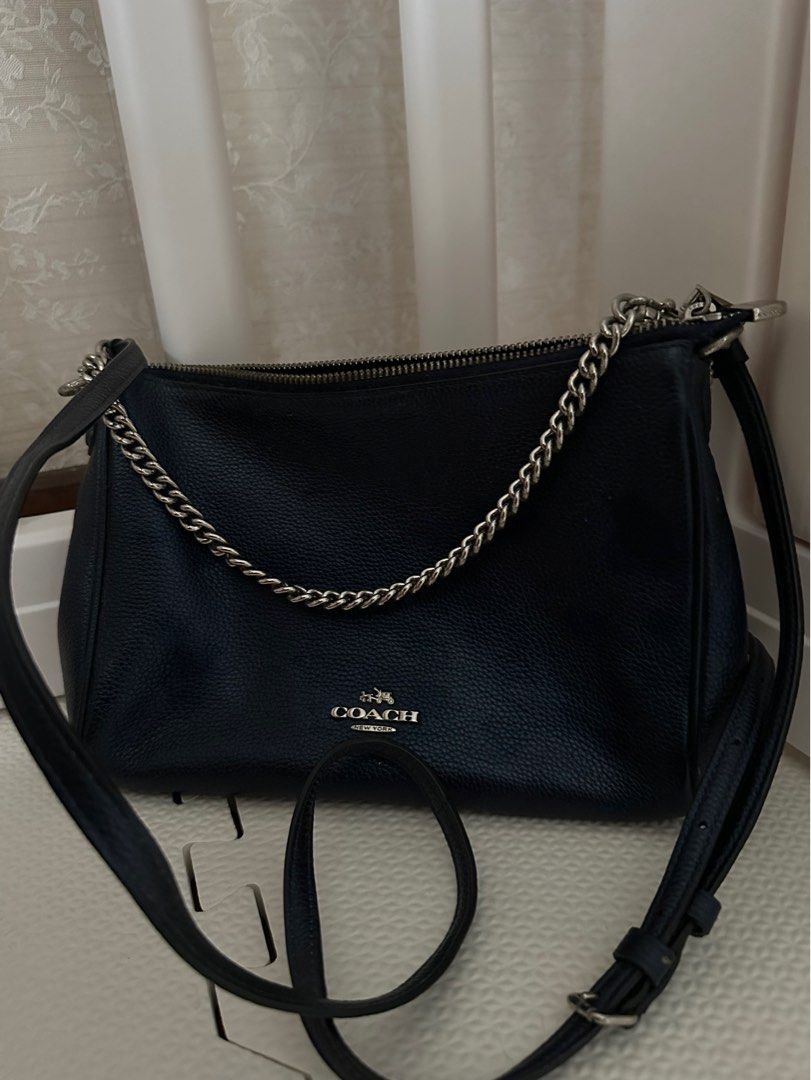 Coach Navy Blue Crossbody Bag (Category: Luxury Bags & Wallets) located in San Juan City. Submitted by smartfindsph (Listing ID 1401539066, Image 1). Description: - Coach crossbody bag - Navy blue leather exterior - Silver chain strap - Zip closure - Detachable and adjustable shoulder strap - Coach logo detail No issues, no flaws Bought from Coach outlet japan.