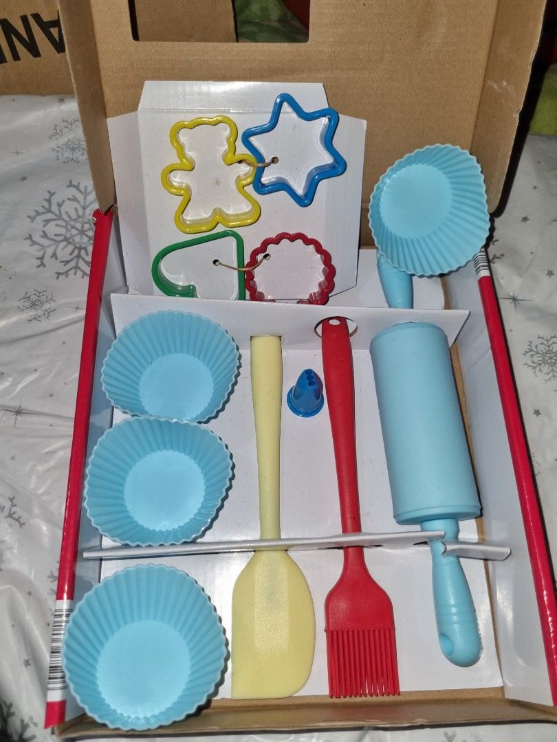 Crofton Kids Baking Set (Category: Bakeware) located in Paombong. Submitted by sweetdeals0181656 (Listing ID 1401645263, Image 2). Description: Crofton Kids Baking Set includes a rolling pin, pastry brush, whisk, spoon, spatula, assorted cookie cutters, cupcake cases, and decorating attachments. It is designed for kids to enjoy baking. The set comes in a red box with a cherry design. Wash in warm water and mild detergent before first use..