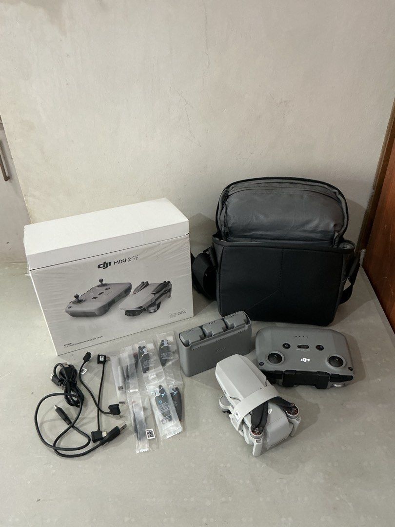 DJI Mini 2 SE Fly More Combo (Category: Drones) located in Manila. Submitted by cefaguilar_ (Listing ID 1401563207, Image 1). Description: DJI Mini 2 SE Fly More Combo. Includes the drone, remote controller, three batteries, charging hub, shoulder bag, and all necessary cables. Features 2.7K/30fps video, 4x digital zoom, and a 31-minute max flight time. It has a 12MP camera and can resist up to level 5 winds. The drone weighs under 249g. RFS: add