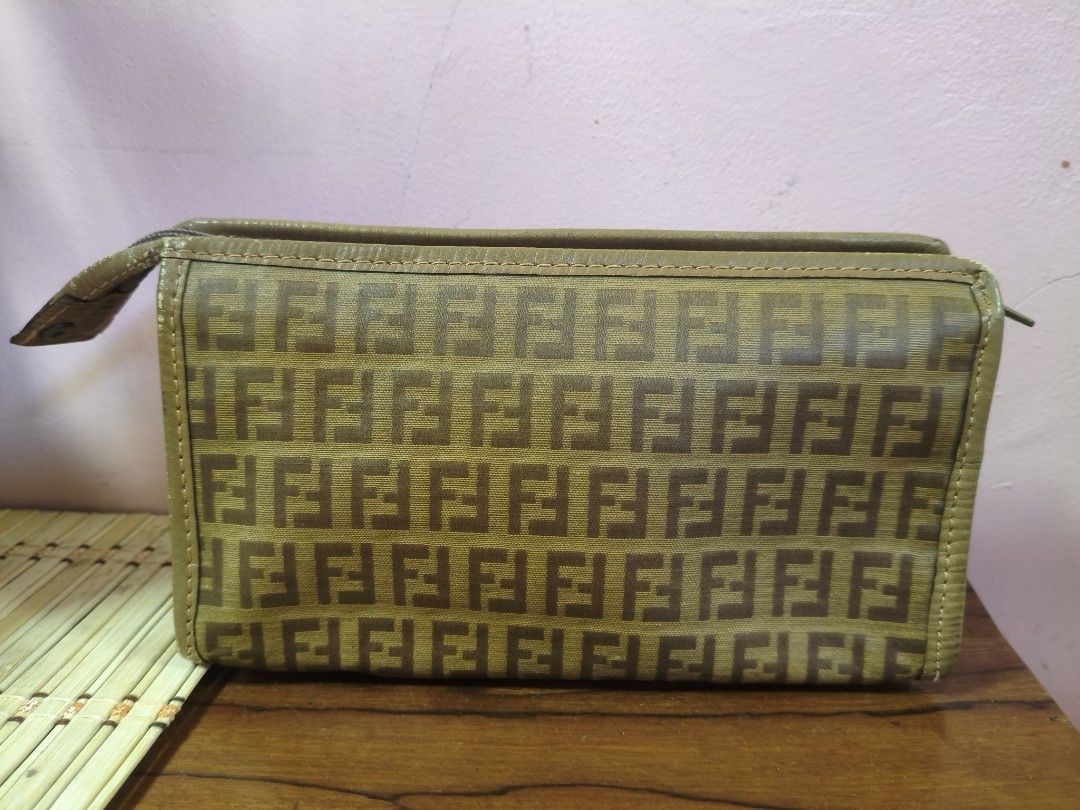 Fendi Zucchino Clutch Bag (Category: Luxury Bags & Wallets) located in Puerto Princesa. Submitted by lotsstuff (Listing ID 1401714607, Image 2). Description: Authentic Fendi Zucchino clutch bag. Features the iconic FF logo pattern. The bag has a zip closure and a wrist strap. The interior includes a pocket. Made in Italy..