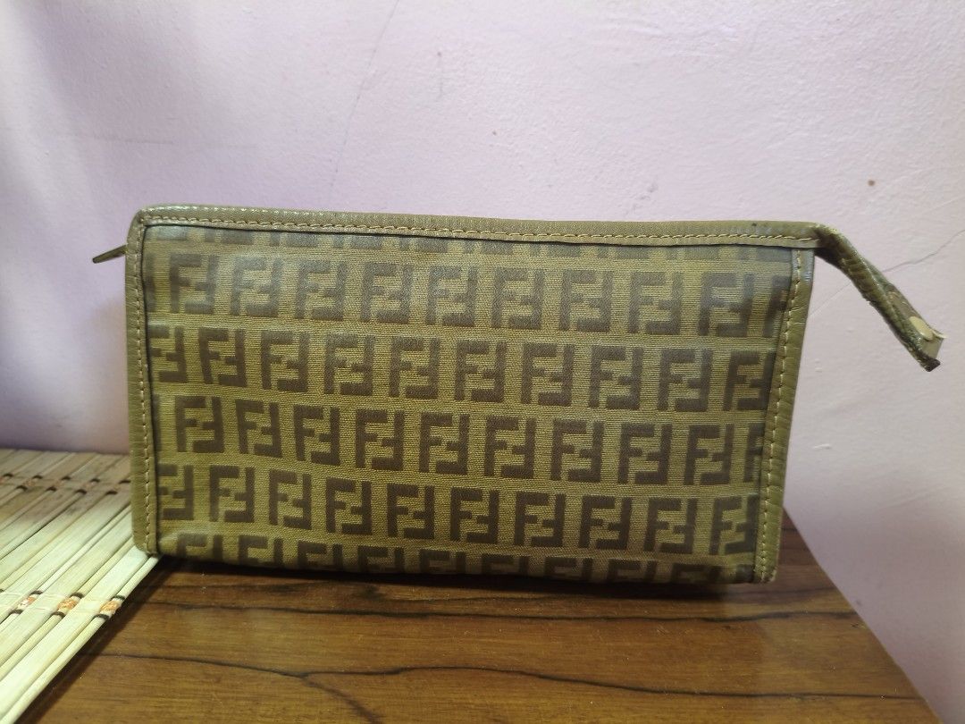 Fendi Zucchino Clutch Bag (Category: Luxury Bags & Wallets) located in Puerto Princesa. Submitted by lotsstuff (Listing ID 1401714607, Image 3). Description: Authentic Fendi Zucchino clutch bag. Features the iconic FF logo pattern. The bag has a zip closure and a wrist strap. The interior includes a pocket. Made in Italy..