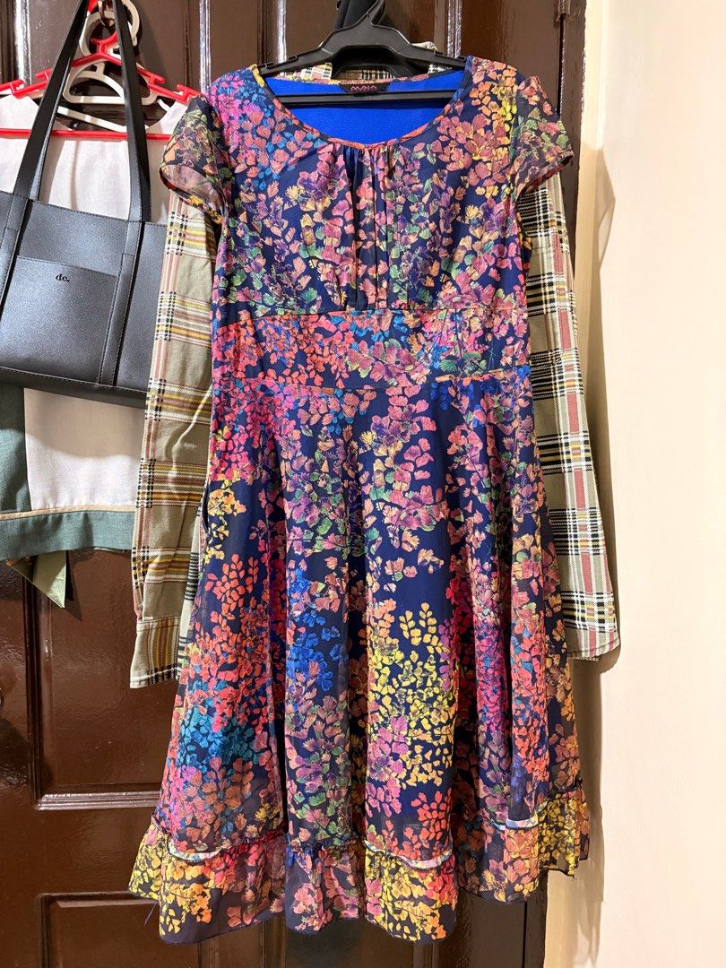 Floral Print Dress (Category: Dresses) located in Manila. Submitted by orion_declutter (Listing ID 1401652574, Image 1). Description: - Maia floral dress - Navy blue base with colorful floral print - Round neckline - Short sleeves - Side zipper closure - Blue inner lining - Suitable for special occasions and everyday wear With minor damage. See last pic.