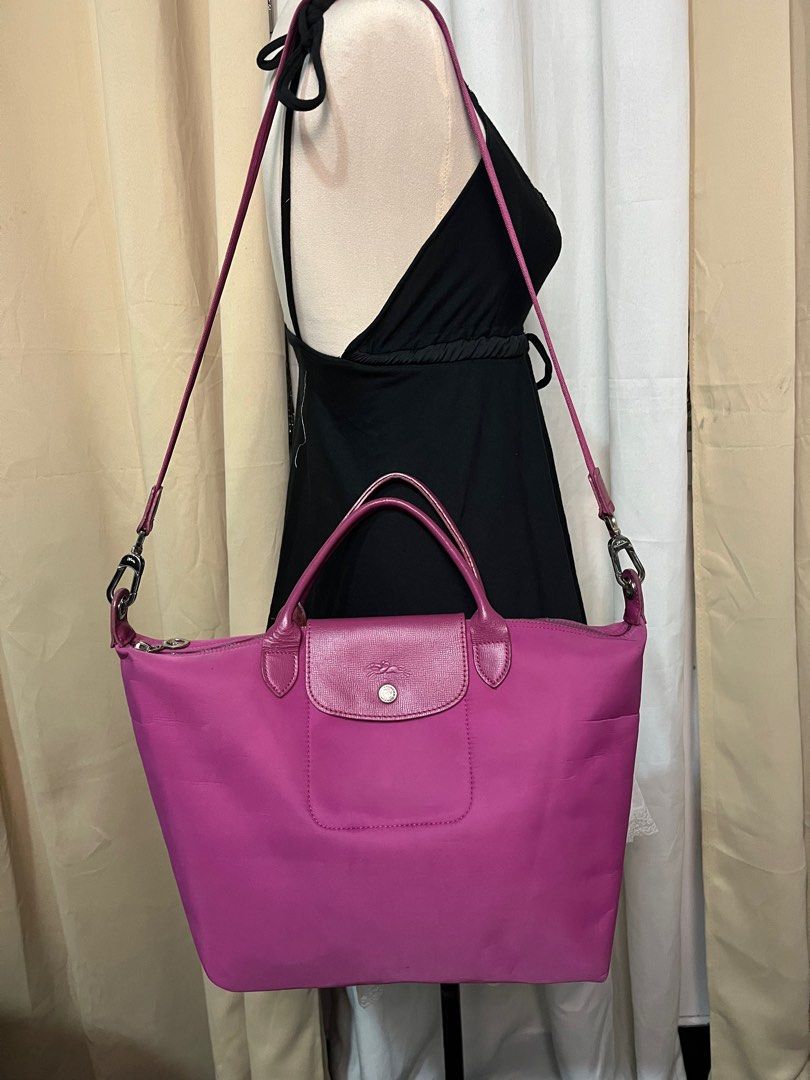 Longchamp Le Pliage Cuir Handbag (Category: Luxury Bags & Wallets) located in Caloocan City. Submitted by witchywardrobe (Listing ID 1401632208, Image 1). Description: - Authentic Longchamp Le Pliage Cuir handbag - Vibrant pink color - Top handle and detachable shoulder strap - Flap closure with snap button - Made in France - Interior slip pocket - Silver-toned hardware - Minor wear on the bottom Made in france *Need wash inner stain.