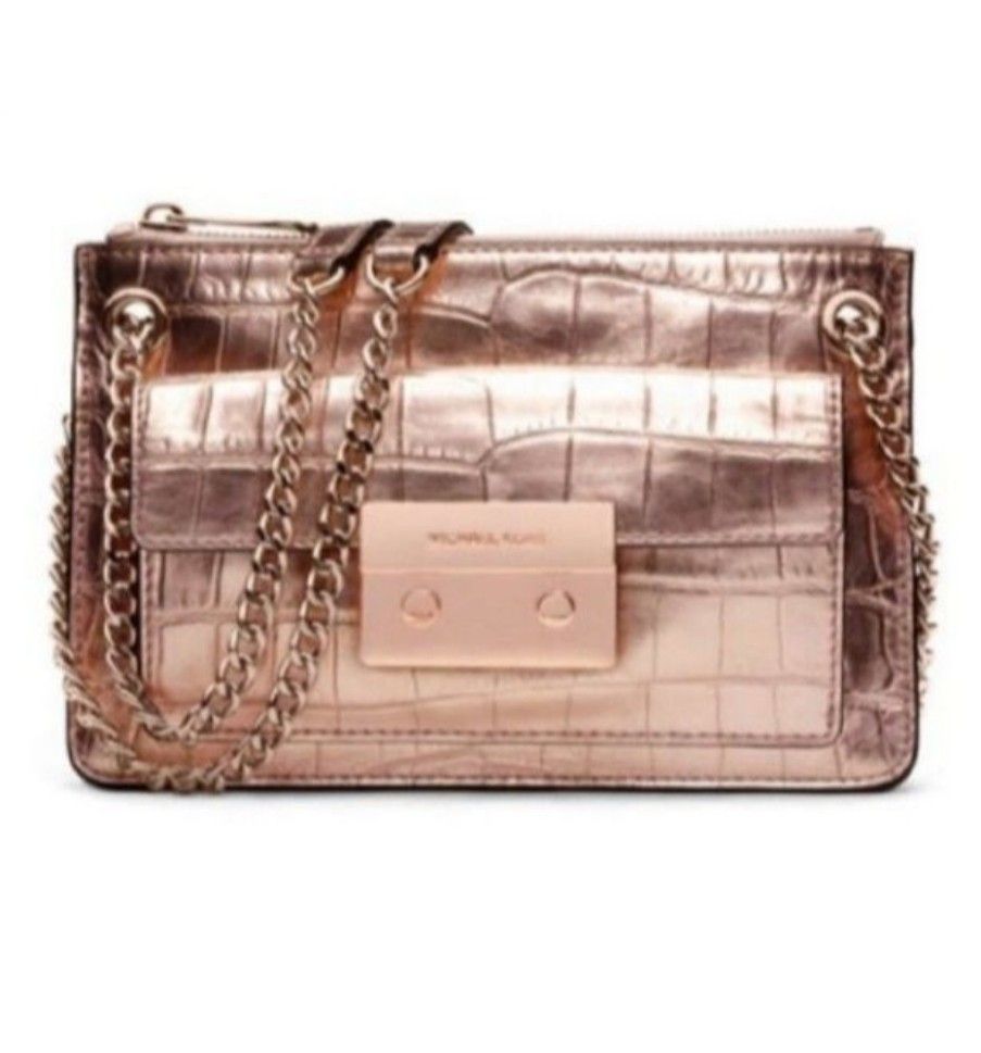Michael KorsRose Gold Metallic Chain Bag (Category: Luxury Bags & Wallets) located in Imus. Submitted by a.niko (Listing ID 1401594163, Image 2). Description: - Michael Kors chain bag - Rose Gold-tone chain strap - Front flap with lock closure - Interior pocket with Michael Kors logo - Crocodile-textured pattern - Michael Kors logo on zipper - With visible signs of wear.
