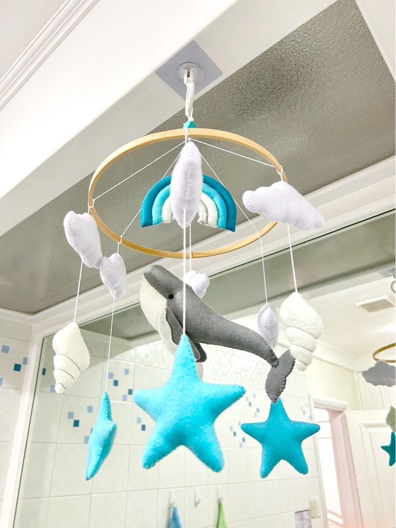 Ocean Theme Felt Crib Mobile Nursery Decor (Category: Cots & Cribs) located in Quezon City. Submitted by rchantong (Listing ID 1401713770, Image 2). Description: - Ocean-themed crib mobile - Features felt whale, stars, clouds, and rainbow - Designed for nursery decoration - Made by Amara Felt.