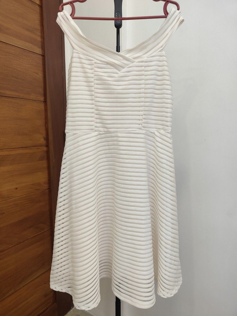 Off-Shoulder White Dress (Category: Dresses) located in Caloocan City. Submitted by cssasot (Listing ID 1401701865, Image 1). Description: Elegant off-shoulder dress in white. Features a flattering A-line silhouette with a textured, striped design. The dress has a fitted bodice and a flared skirt. It includes a zipper closure at the back. Perfect for special occasions or a chic everyday look. Can fit from XS to L Location: 8th Avenue Caloocan Can