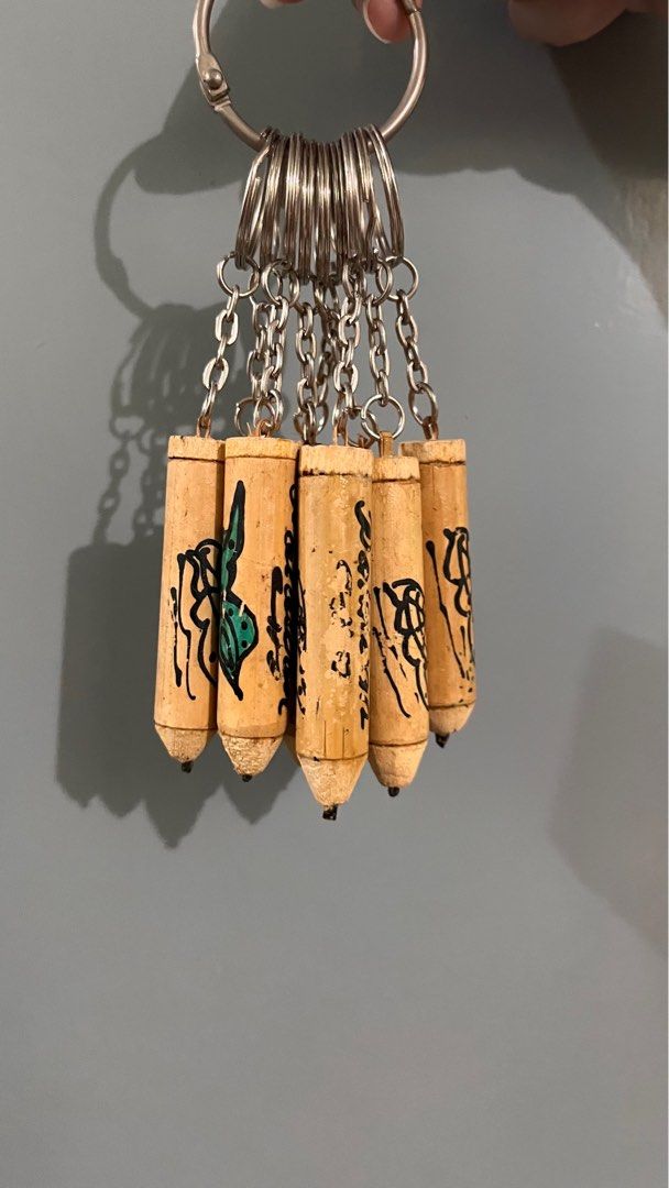 Palawan Souvenir Keychains 9pcs (Category: Vintage Collectibles) located in Manila. Submitted by decluttify (Listing ID 1401698583, Image 2). Description: 9pcs of Palawan Souvenir Keychains - Set of miniature pencil keychains - Each keychain has a unique design and text - Designs may represent different symbols for Palawan - Attached to silver keyrings with small chains - Made of wood with black and green ink details #pasalubong #gift #freebie.