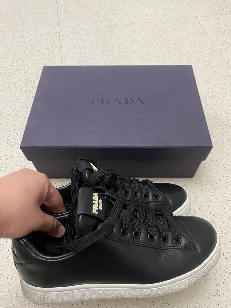 Prada Milano Black Leather Sneakers (2EG400) (Category: Sneakers) located in Makati City. Submitted by glb07 (Listing ID 1401583009, Image 3). Description: - Prada Milano sneakers - Black leather - White sole - Black laces - Prada logo on tongue - Includes original Prada box - Stylish and versatile.