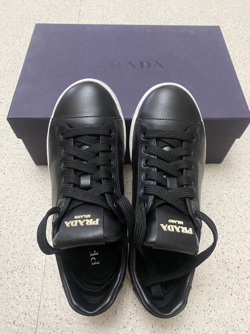 Prada Milano Black Leather Sneakers (2EG400) (Category: Sneakers) located in Makati City. Submitted by glb07 (Listing ID 1401583009, Image 2). Description: - Prada Milano sneakers - Black leather - White sole - Black laces - Prada logo on tongue - Includes original Prada box - Stylish and versatile.