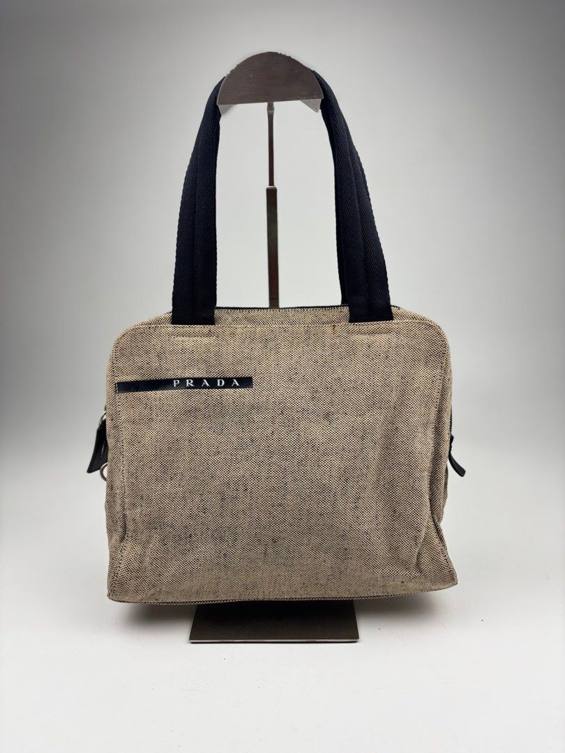 Prada Sports Canvas Handbag (Category: Luxury Bags & Wallets) located in Makati City. Submitted by ragrepository (Listing ID 1401642601, Image 1). Description: Prada Sports Canvas Handbag Height-8.5” Width- 10” Depth- 3.5” Handle Drop-6.5” Condition-9/10 Flaw-Stain, signs of wear .