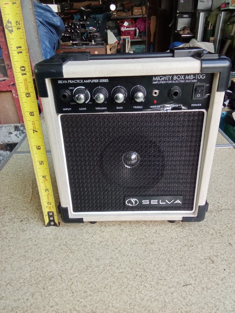 Selva Mighty Box MB-10G Practice Amplifier (Category: Soundbars, Speakers & Amplifiers) located in San Pedro. Submitted by trisheljas_japansurplus (Listing ID 1401683491, Image 1). Description: Selva Mighty Box MB-10G practice amplifier for electric guitars. Features input, gain, volume, bass, and treble controls. Includes aux in and headphone jacks. Power switch is located on the front panel. The back panel has a power cord and a sticker with sp