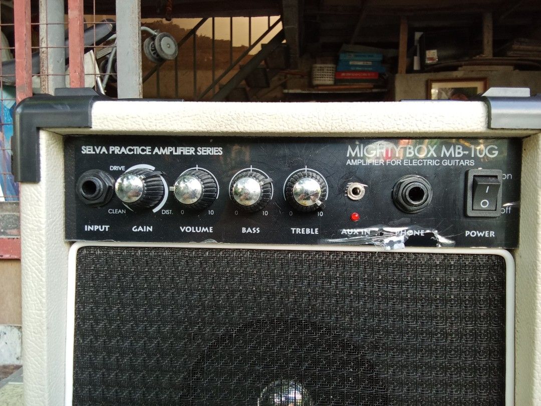 Selva Mighty Box MB-10G Practice Amplifier (Category: Soundbars, Speakers & Amplifiers) located in San Pedro. Submitted by trisheljas_japansurplus (Listing ID 1401683491, Image 2). Description: Selva Mighty Box MB-10G practice amplifier for electric guitars. Features input, gain, volume, bass, and treble controls. Includes aux in and headphone jacks. Power switch is located on the front panel. The back panel has a power cord and a sticker with sp