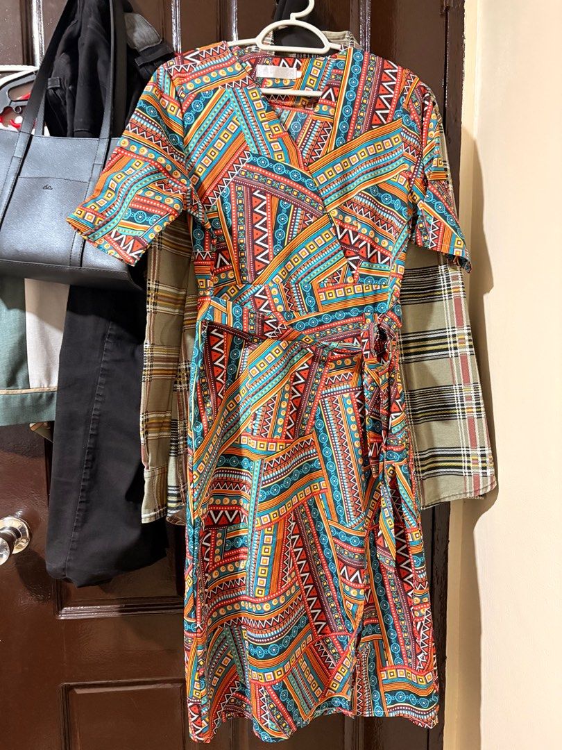 Wrap Dress with Geometric Print (Category: Dresses) located in Manila. Submitted by orion_declutter (Listing ID 1401651870, Image 1). Description: Best fit Small - Wrap dress with a vibrant geometric pattern (orange, blue, brown). - Short sleeves. - Tie closure at the waist. - Side zipper. - Stylish and versatile design..