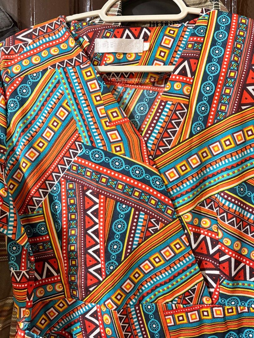 Wrap Dress with Geometric Print (Category: Dresses) located in Manila. Submitted by orion_declutter (Listing ID 1401651870, Image 3). Description: Best fit Small - Wrap dress with a vibrant geometric pattern (orange, blue, brown). - Short sleeves. - Tie closure at the waist. - Side zipper. - Stylish and versatile design..