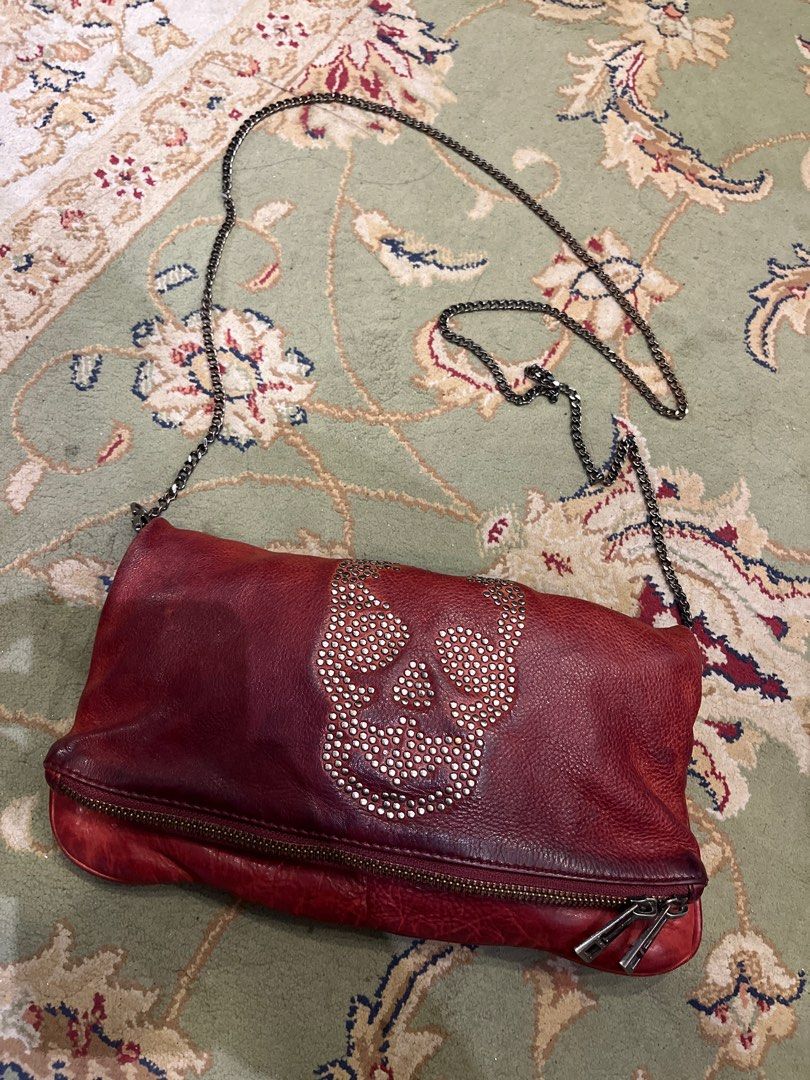 Zadig & Voltaire Skull Embellished Shoulder Bag (Category: Luxury Bags & Wallets) located in Cagayan de Oro. Submitted by gdsteals (Listing ID 1401651388, Image 2). Description: - Zadig & Voltaire shoulder bag - Red leather - Skull and stud embellishment - Chain strap - Zip closure - Embossed brand name - Stylish and edgy design.