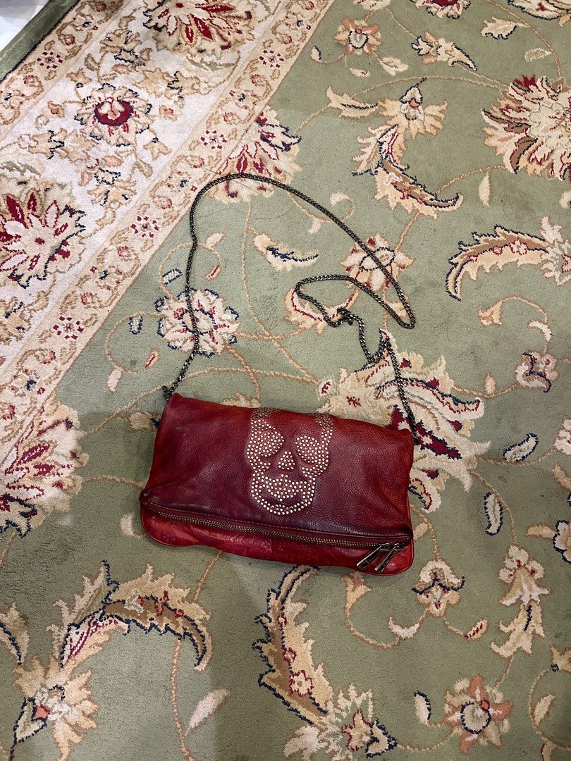 Zadig & Voltaire Skull Embellished Shoulder Bag (Category: Luxury Bags & Wallets) located in Cagayan de Oro. Submitted by gdsteals (Listing ID 1401651388, Image 1). Description: - Zadig & Voltaire shoulder bag - Red leather - Skull and stud embellishment - Chain strap - Zip closure - Embossed brand name - Stylish and edgy design.