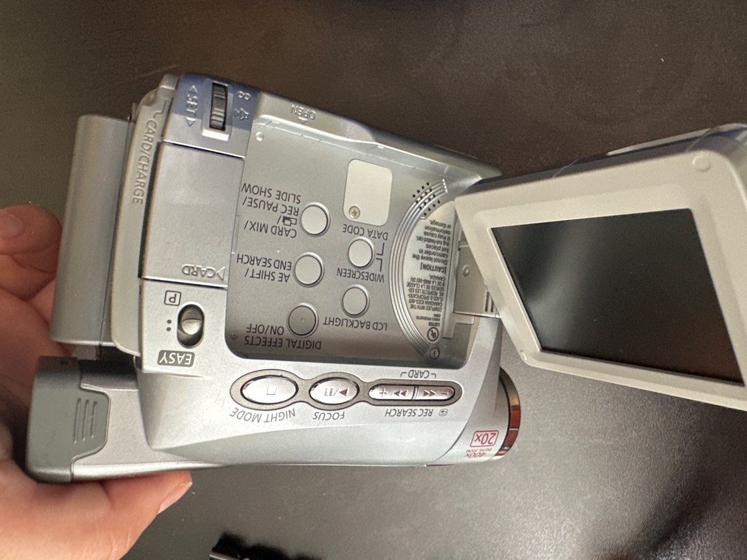 Canon Camcorder 20x Zoom (Category: Cameras) located in Manila. Submitted by sumdeclutter (Listing ID 1403252385, Image 2). Description: - Canon camcorder with 20x zoom lens - Features a flip-out LCD screen - Includes a comfortable hand strap - Lens specifications: 2.8-56mm, f1.6 - Silver body.
