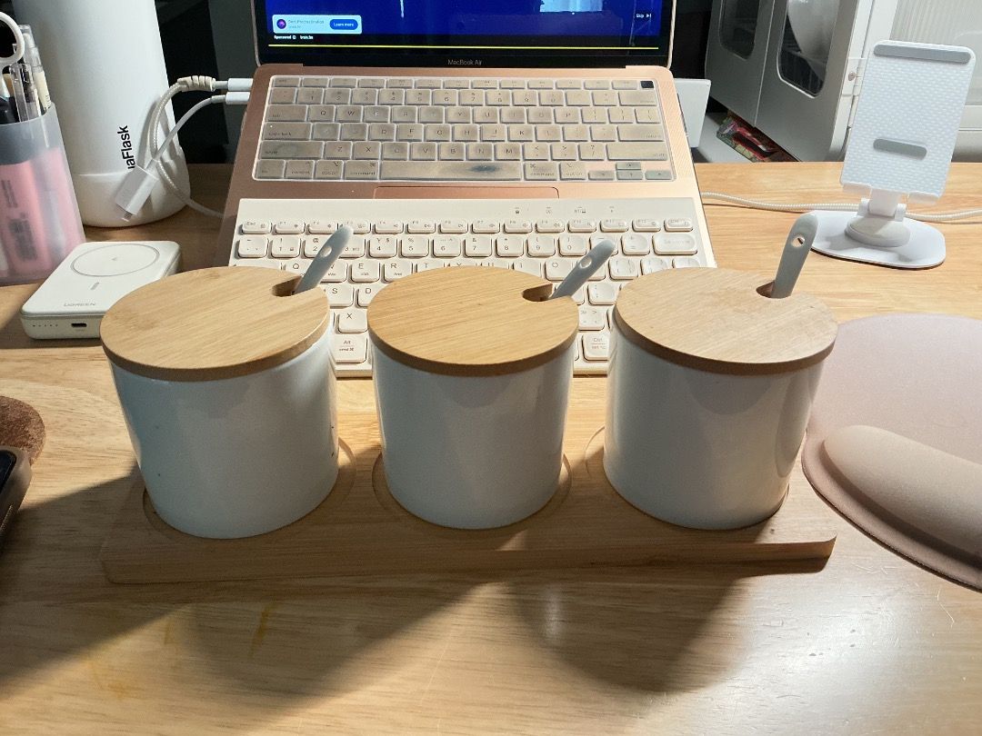 Ceramic Spice Jar Set with Wooden Lids (Category: Food Organization & Storage) located in Mandaluyong City. Submitted by keenfox-a0cb (Listing ID 1403292718, Image 3). Description: - Set includes three white ceramic spice jars. - Comes with wooden lids and small spoons. - Jars are cylindrical and clean. - Includes a wooden tray for organization. - Ideal for storing spices, herbs, or small ingredients. B.