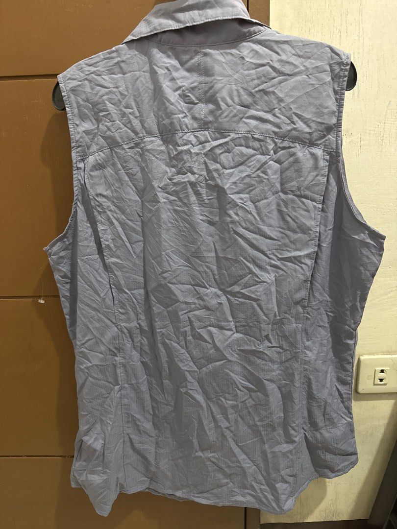 Columbia Sleeveless Shirt (Category: Activewear) located in San Pablo. Submitted by ShopbyLiz (Listing ID 1403320455, Image 3). Description: - Columbia sleeveless shirt - bluish gray - Button-down front - Collared neckline - Columbia logo on chest - Lightweight, quick-drying material - authentic - small pocket inside as per 7th photo - Perfect for warm weather.