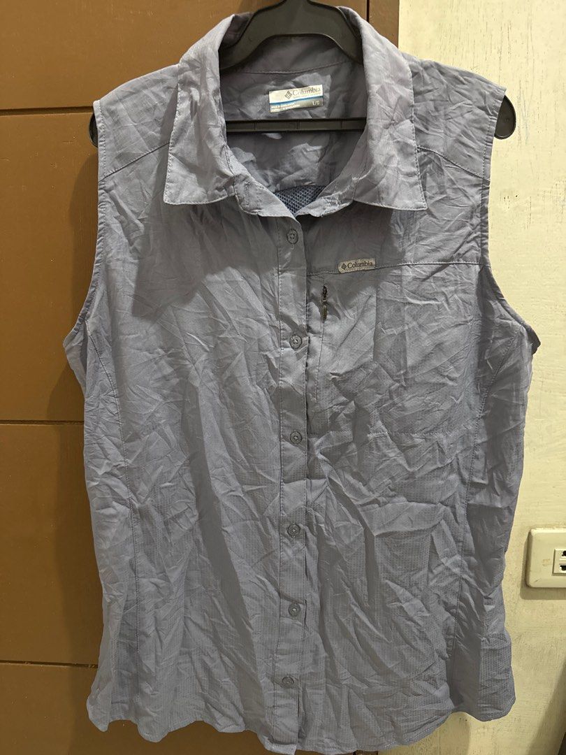 Columbia Sleeveless Shirt (Category: Activewear) located in San Pablo. Submitted by ShopbyLiz (Listing ID 1403320455, Image 2). Description: - Columbia sleeveless shirt - bluish gray - Button-down front - Collared neckline - Columbia logo on chest - Lightweight, quick-drying material - authentic - small pocket inside as per 7th photo - Perfect for warm weather.