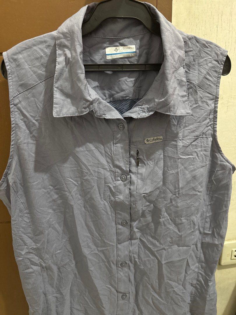 Columbia Sleeveless Shirt (Category: Activewear) located in San Pablo. Submitted by ShopbyLiz (Listing ID 1403320455, Image 1). Description: - Columbia sleeveless shirt - bluish gray - Button-down front - Collared neckline - Columbia logo on chest - Lightweight, quick-drying material - authentic - small pocket inside as per 7th photo - Perfect for warm weather.