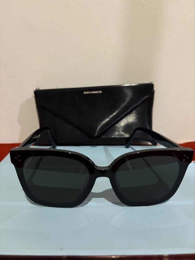 Gentle Monster HER 01 SUNGLASSES (Category: Sunglasses & Eyewear) located in Mandaluyong City. Submitted by bluezzzzz (Listing ID 1403341515, Image 1). Description: AE - Authentic Gentle Monster HER 01 sunglasses - Black frame with dark lenses - Includes box and cleaning cloth - Features a stylish, oversized design - Gentle Monster logo visible on case and paperwork - Perfect accessory.