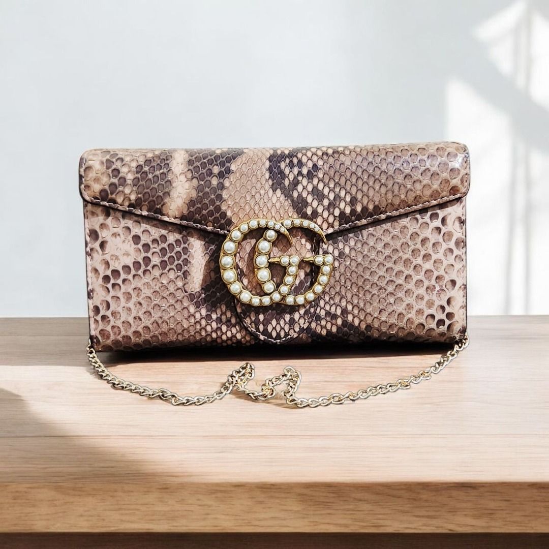 Gucci GG Marmont Python Chain Wallet (guaranteed) (Category: Luxury Bags & Wallets) located in Caloocan City. Submitted by wearandcarry (Listing ID 1403335960, Image 1). Description: - Gucci GG Marmont chain wallet - Snakeskin exterior - Pearl-embellished GG logo - Chain strap - Flap closure - Brown and beige color palette - Rectangular shape - Textured finish.