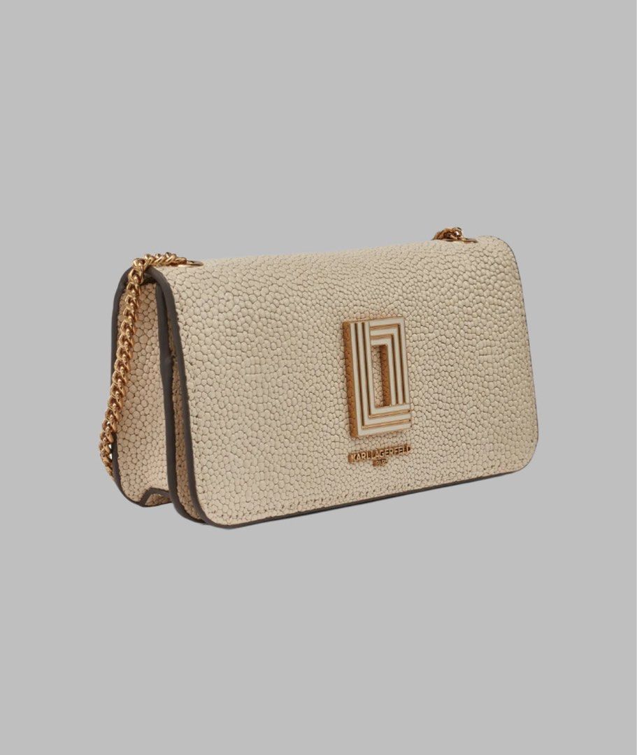 Karl Lagerfeld Chain Bag (Category: Luxury Bags & Wallets) located in Lapu Lapu. Submitted by Tinay (Listing ID 1403236945, Image 2). Description: - Karl Lagerfeld chain bag - Neutral color - Textured exterior - Gold-tone chain strap - Features Karl Lagerfeld logo - Flap closure - Compact size Shoulder bag measures approx. 5” H x 8” W x 4" D Shoulder strap measures approx. 21" L; Handle Drop measures approx. 6" L Shoulder bag Weighs approx. 1 Lb.