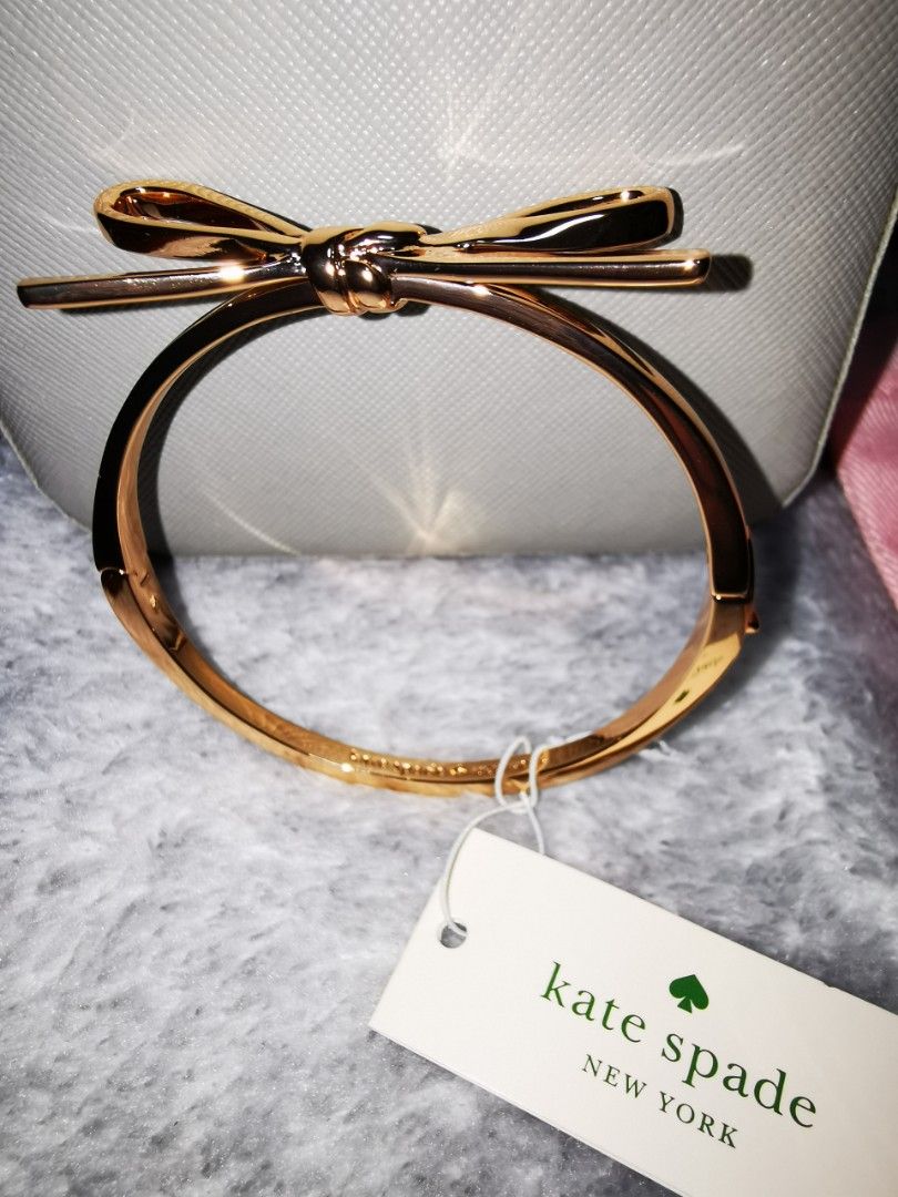 Kate Spade Bangle (Category: Bracelets) located in Pasig City. Submitted by puggable (Listing ID 1403414409, Image 2). Description: New / Kept Unused Kate Spade Bow Bangle in Rose Gold With KS Pink Pouch Guaranteed Authentic Bought from US **Decluttering**.