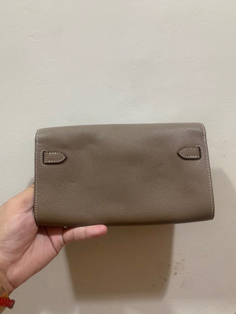 Kelly Wallet (Category: Luxury Bags & Wallets) located in Manila. Submitted by moneymann888 (Listing ID 1403336897, Image 3). Description: Sf Buyer Shoulder - Kelly wallet - Taupe exterior - Silver-tone clasp - Interior with zippered compartment and multiple card slots - White stitching details - Leather strap closure .