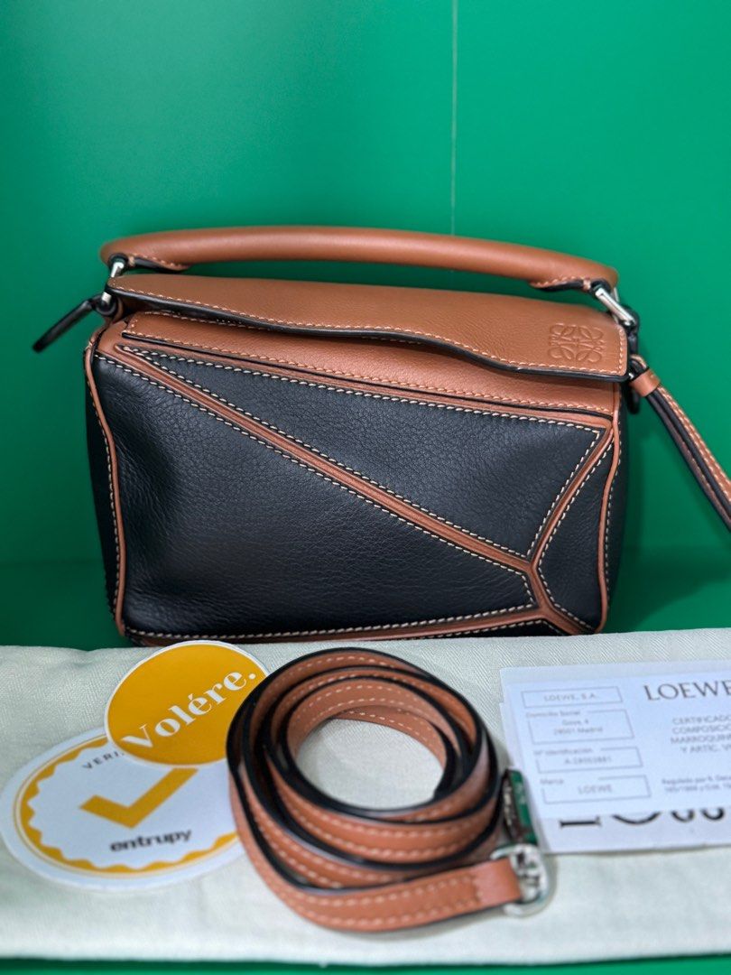 Loewe Puzzle Mini in Black-Tan (Category: Luxury Bags & Wallets) located in Quezon City. Submitted by voleremnl (Listing ID 1403358296, Image 1). Description: ❗️₱92K ❗️Loewe Puzzle Mini in Black-Tan UNUSED CONDITION; practically brand new, with only minor signs of prolonged storage Comes with dust bag, cards, and Entrupy authenticity certificate. Brand new price: 160-200K in Greenbelt This is the classic, OG Puzzle design! .