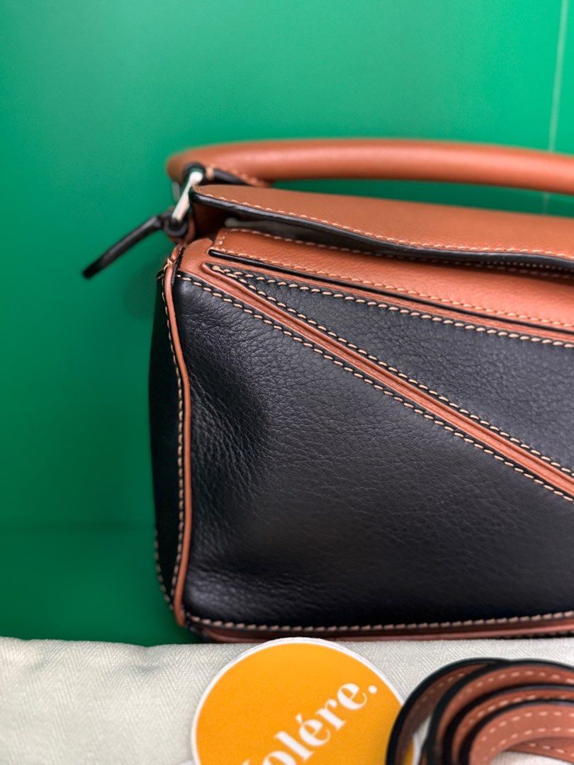 Loewe Puzzle Mini in Black-Tan (Category: Luxury Bags & Wallets) located in Quezon City. Submitted by voleremnl (Listing ID 1403358296, Image 3). Description: ❗️₱92K ❗️Loewe Puzzle Mini in Black-Tan UNUSED CONDITION; practically brand new, with only minor signs of prolonged storage Comes with dust bag, cards, and Entrupy authenticity certificate. Brand new price: 160-200K in Greenbelt This is the classic, OG Puzzle design! .