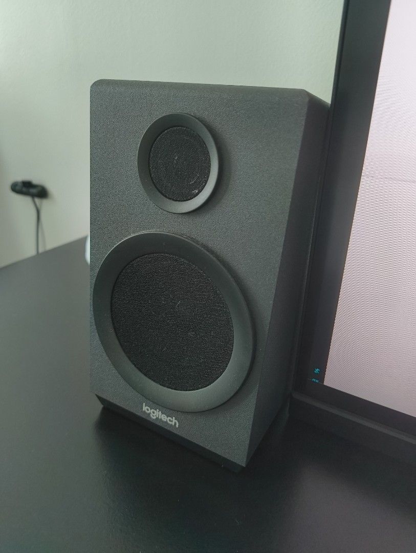 Logitech Z333 Speaker System (Category: Soundbars, Speakers & Amplifiers) located in Manila. Submitted by lodburger (Listing ID 1403285074, Image 2). Description: - Logitech Z333 speaker system - Includes subwoofer and two satellite speakers - Features a control pod with power indicator - Sleek black design - Logitech logo visible on speakers - Subwoofer with side port.
