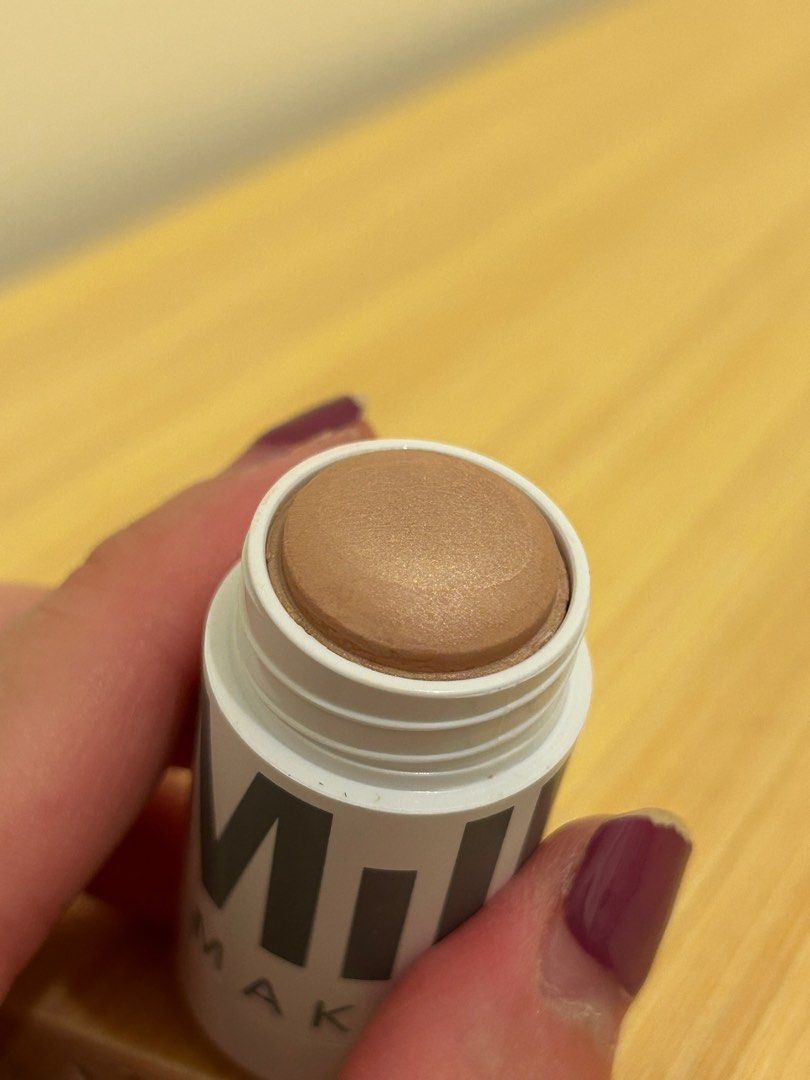 Milk Makeup Lit Highlighter (Category: Makeup) located in Mandaluyong City. Submitted by rfsneedfunds (Listing ID 1403343820, Image 3). Description: - Milk Makeup Lit Highlighter in 'Lit' shade - Creamy and buildable formula - Provides a natural glow - Product weight: 0.24 oz / 6.7g - Light bronze color - faulty screw:( use brush or scooper should you finish top contents already.