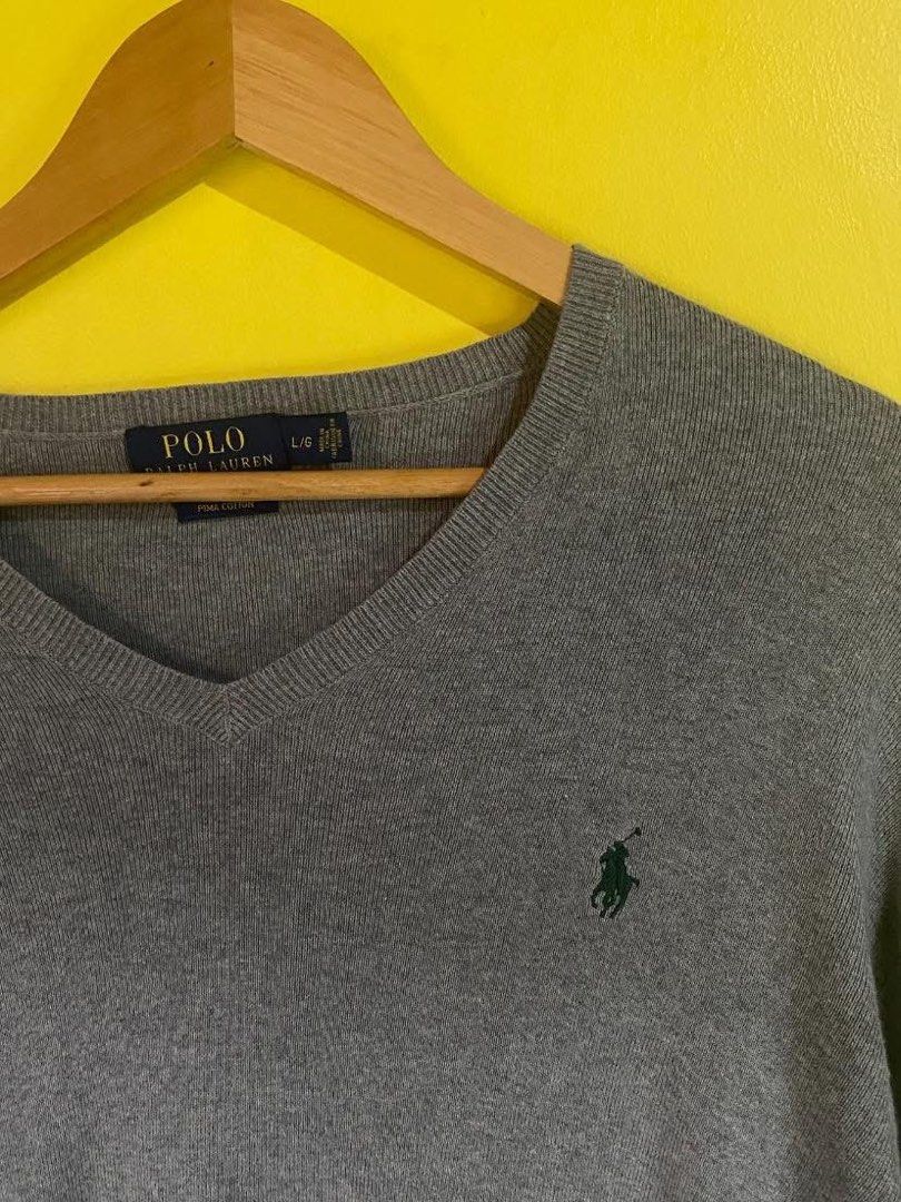 Polo Ralph Lauren V-Neck Sweater (Category: Coats, Jackets and Outerwear) located in Baler. Submitted by czarr_ (Listing ID 1403271487, Image 2). Description: - Polo Ralph Lauren V-neck sweater - Gray color - Features the iconic Polo logo - Made of fine cotton - Size: L - Versatile for layering or standalone wear.