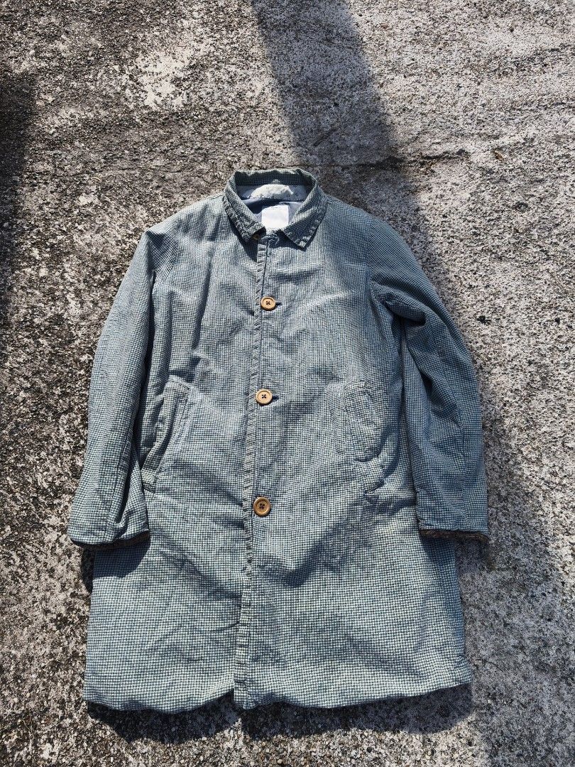 Visvim Checked Coat (Category: Coats, Jackets and Outerwear) located in Kuala Lumpur. Submitted by xclayzzy (Listing ID 1403396841, Image 1). Description: Visvim checked coat. Features a button-up front, collar, and long sleeves. The coat has a blue and white checkered pattern. The label indicates the coat is made in Japan and is a size 3. The material composition includes cotton and linen..