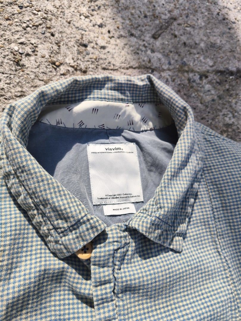 Visvim Checked Coat (Category: Coats, Jackets and Outerwear) located in Kuala Lumpur. Submitted by xclayzzy (Listing ID 1403396841, Image 3). Description: Visvim checked coat. Features a button-up front, collar, and long sleeves. The coat has a blue and white checkered pattern. The label indicates the coat is made in Japan and is a size 3. The material composition includes cotton and linen..