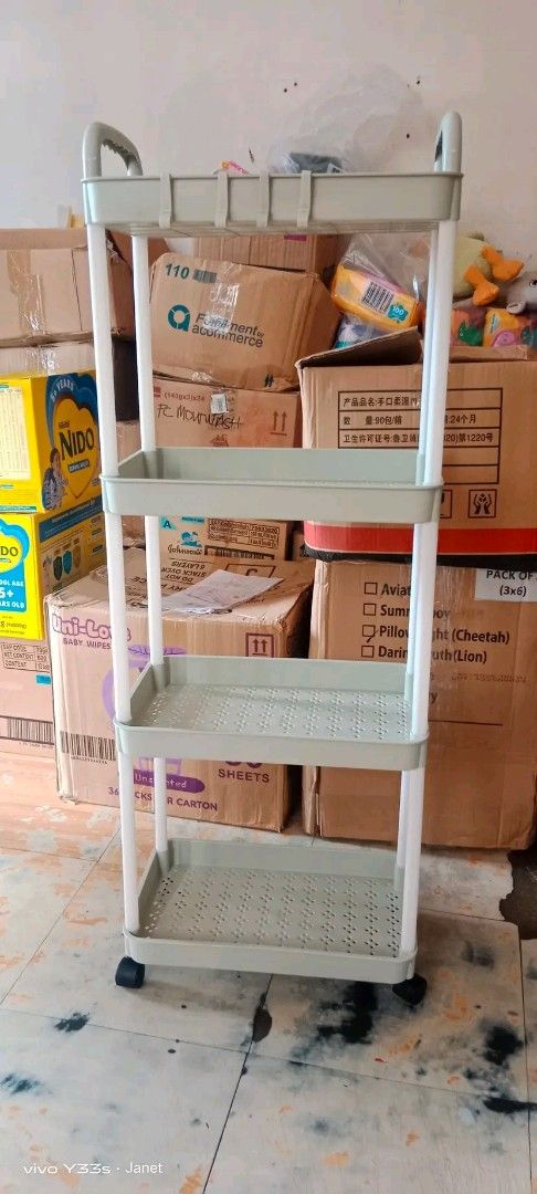 4-Tier trolley Cart with Handle (Category: Other Kitchenware & Tableware) located in Caloocan City. Submitted by janeil23452 (Listing ID 1403520740, Image 1). Description: 4-tier trolley cart is perfect for organizing items. It features a handle for easy maneuverability and four shelves for storage. The cart has a light green color and is supported by white poles. It has wheels for easy movement. Ideal for use in the kitchen, bathroom, or any spa