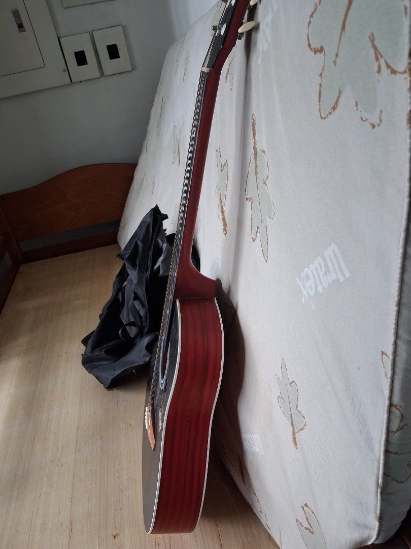 Acoustic Guitar - Black and Red (Category: Musical Instruments) located in Manila. Submitted by 88888av (Listing ID 1403538217, Image 2). Description: - Black acoustic guitar - Red neck and back - White pickguard - Decorative soundhole design - Includes a black carrying case - Six tuning pegs.